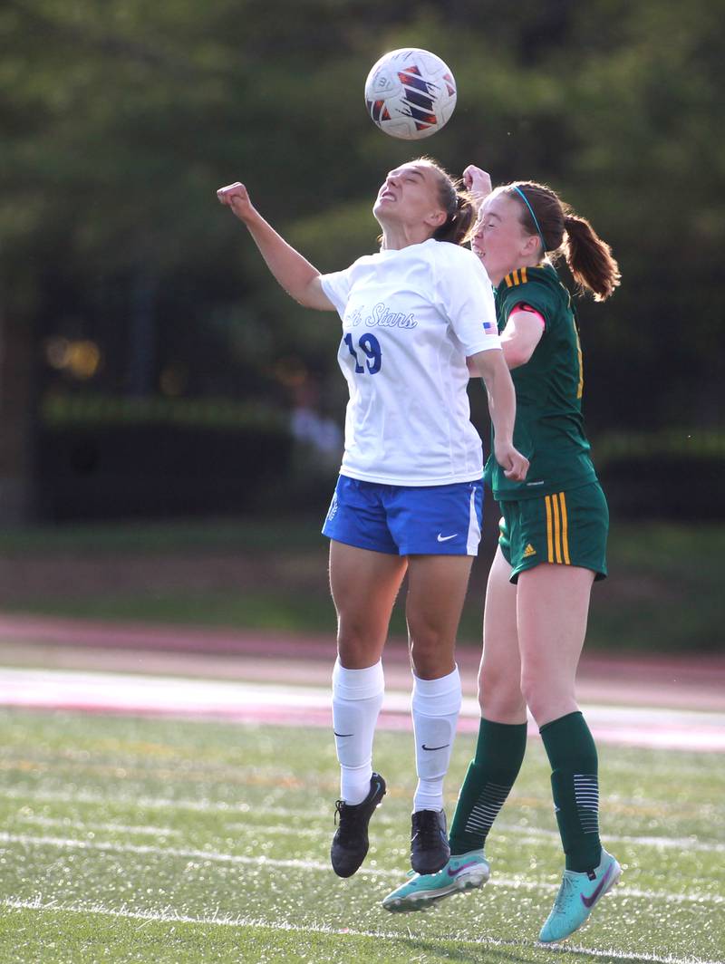St. Charles North’s Laney Stark (left) and Fremd’s Maddie McMillan head the ball during the Class 3A state semifinal game at North Central College in Naperville on Friday, May 31, 2024.