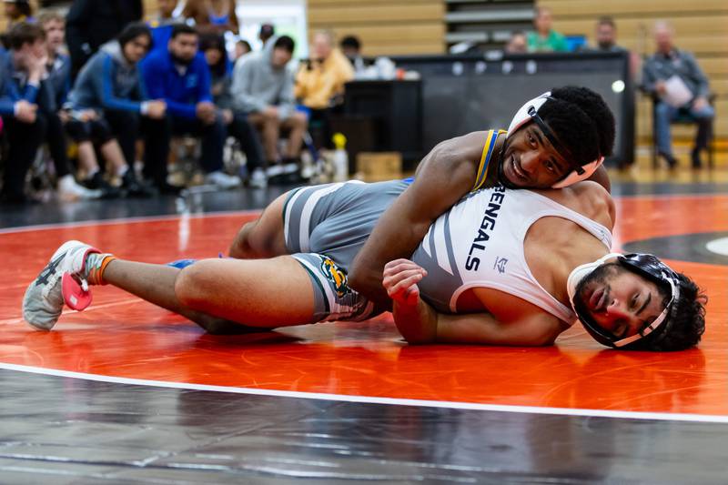 Joliet Central's Tremaine Cooper goes up against Muhammad Ali Hasib of Plainfield East in the 150-pound match at Plainfield East on Dec. 12, 2024.