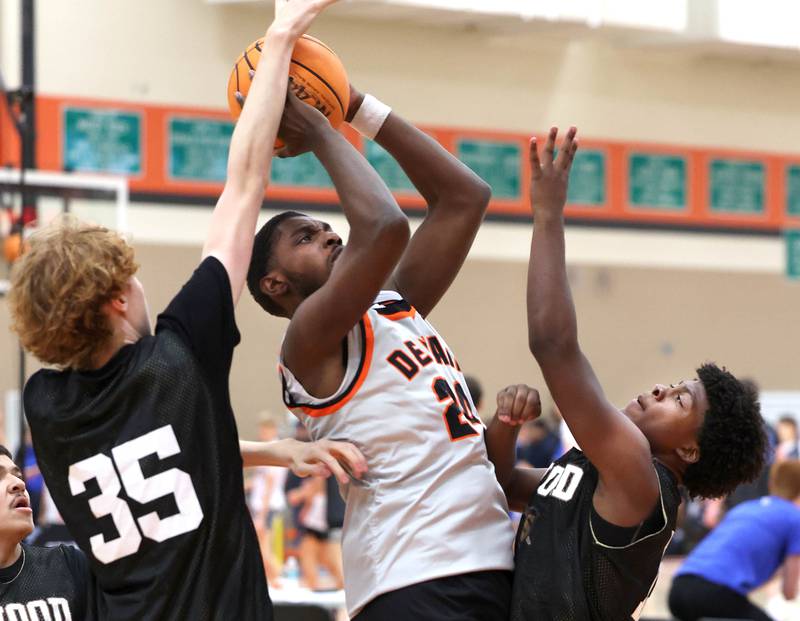 DeKalb’s Myles Newman goes between defenders Friday, June 20, 2025, during their game against Streamwood in the DeKalb Live summer tournament at DeKalb High School.