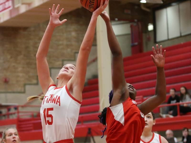Ottawa's Hailey Larsen and Streator's Shantell Morton reaches up to grab a rebound during the Lady Pirate Holiday Tournament on Wednesday, Dec. 20, 2023 in Kingman Gym.