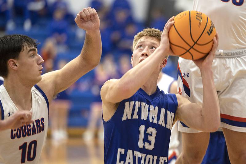 Newman’s George Jungerman looks to put up a shot against Eastland’s Zyacn Haverland Tuesday, Dec. 10, 2024, at Eastland High School.