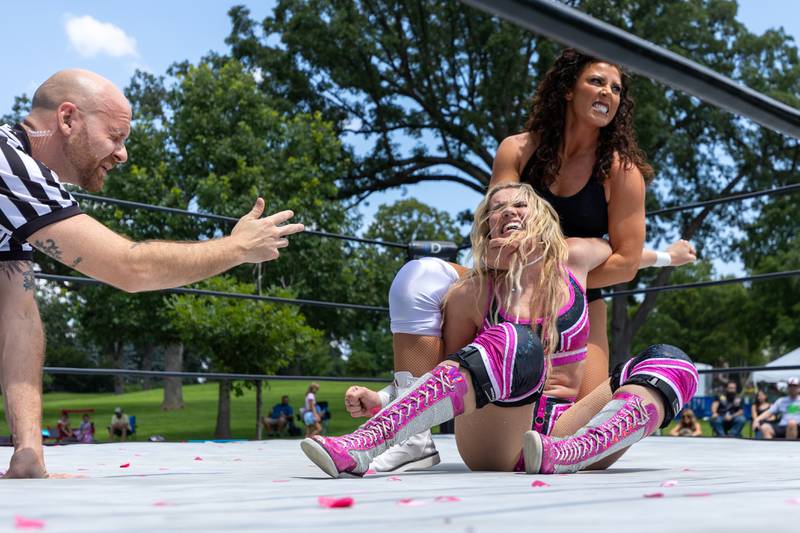 (left to right) Referee Derek Martha checks for tap as Brittnie Brooks is held in submission hold by J-Rod at the Taste of the Illinois Valley DreamWave Wrestling event on Saturday, August 2, 2025 at Centennial Park in Peru.