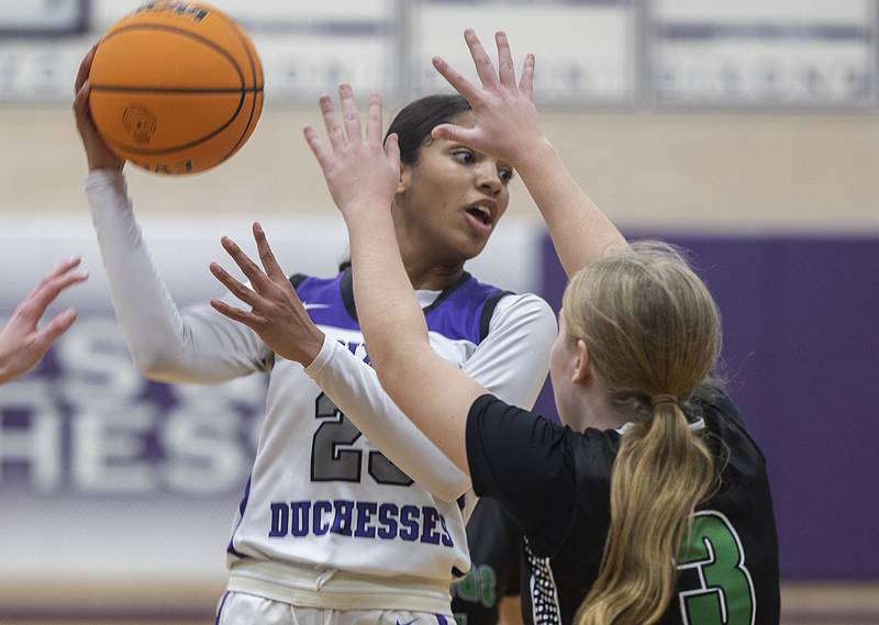 Dixon's Ahmyrie McGowan looks to pass against North Boone’s Addison Silvers Thursday, Dec. 19, 2024, at Dixon High School.