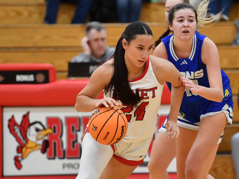 Benet’s Emma Briggs (24) drives away from Lyons Township’s Emma O'Brien during a game on November 18, 2025 at Benet Academy in Lisle.