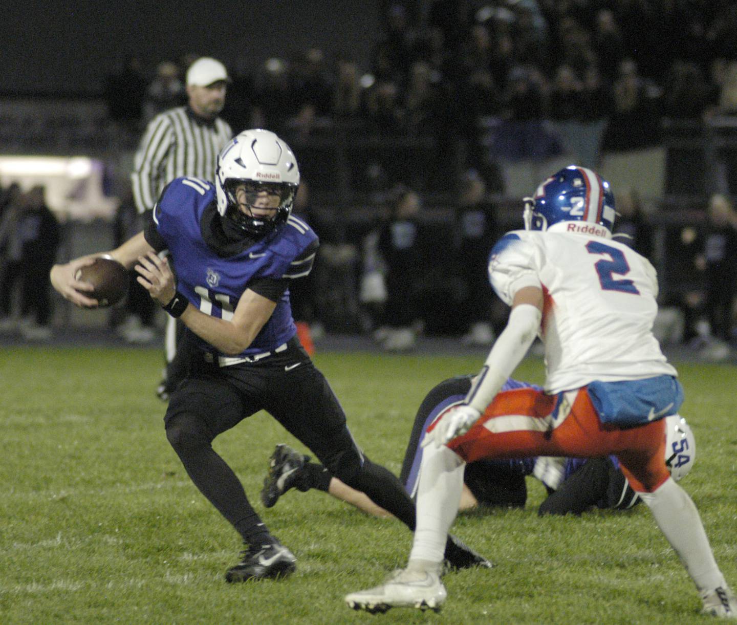 Dixon QB  Jagger Kemp runs outside to avoid a tackle  . Genoa-Kingston traveled to Dixon to take on the Dukes. The game took place on Dixon's Senior Night, October 24th, 2025