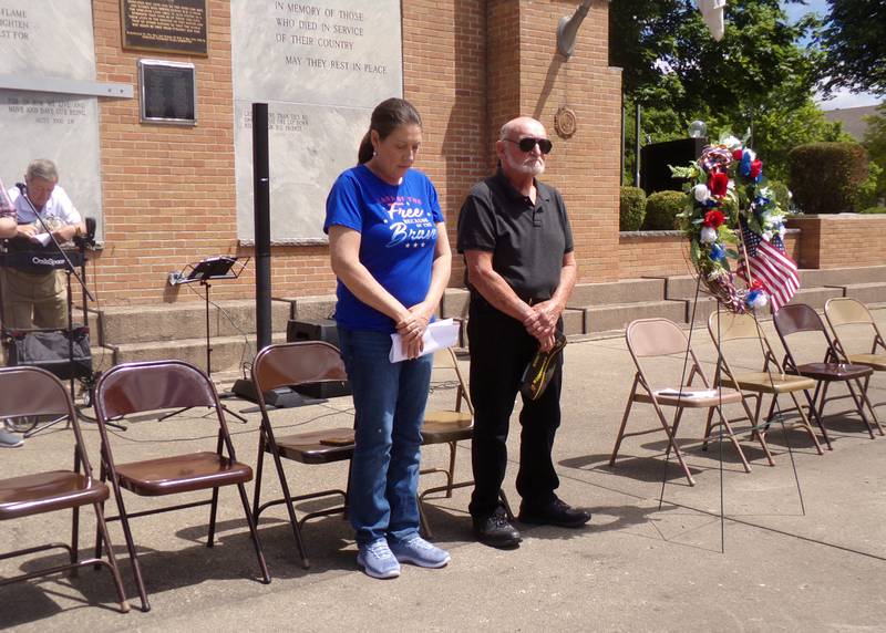 Bobby Sue Franklin (left) and Jim Limberg, Post 1492 VFW commander, stand for a moment of silence Monday, May 27, 2024, during the Memorial Day ceremony at Veterans Memorial Plaza in Streator's City Park.