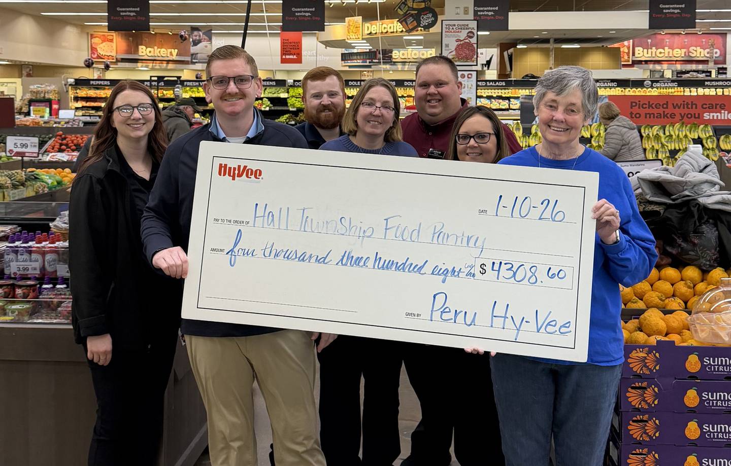 Peru Hy-Vee district store director BJ Rissi presents a check to the Hall Township Food Pantry.  The Peru Hy-Vee raised a total of $4,308.60 from the round-up campaign and the pantries each received $2,154.30 to support their hunger-fighting efforts.