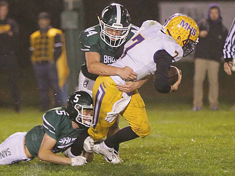 Mendota's quarterback Ted Landgraf, runs with the football as he is brought down by St. Bede's Callan Hueneburg (no,5) and teammate Jake Jackson (no,44) on Thursday Oct. 21, 2021