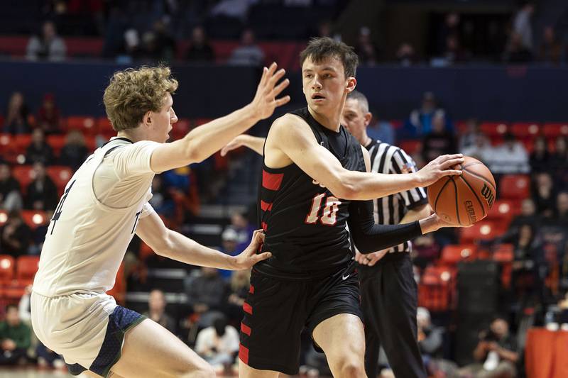 Benet Academy’s Andy Nash looks to pass against New Trier Friday March 10, 2023 during the 4A IHSA Boys Basketball semifinals.