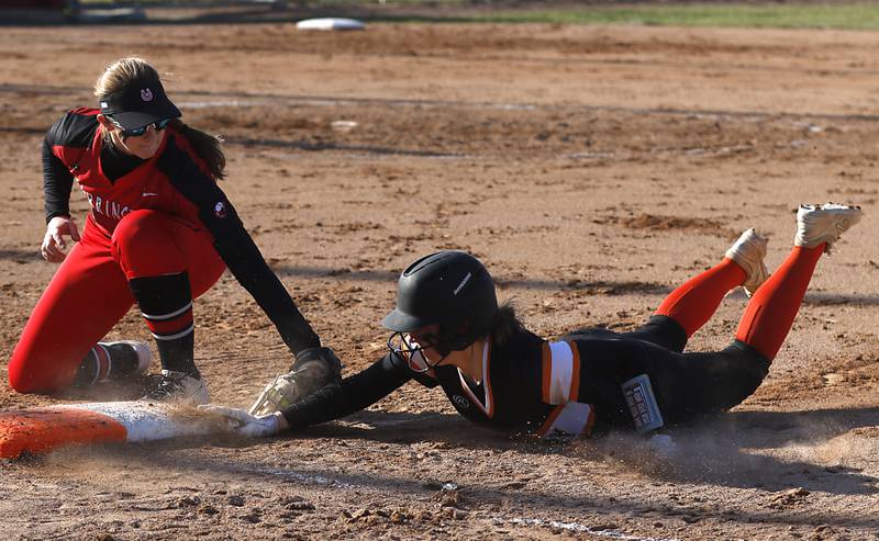Barrington’s Ainsley Muno tries to tag McHenry's Emma Stolzman as she dive back to first base during a non-conference softball game Friday, April 1, 2022, between McHenry and Barrington at Barrington High School.