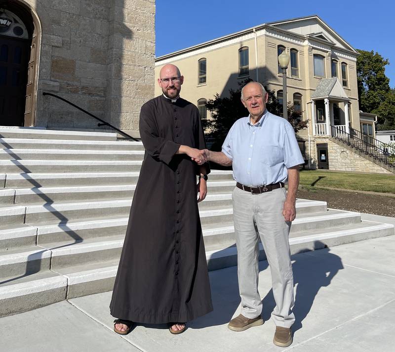 The Rev. Father Tom Otto (right), pastor of St. Patrick's Catholic Church in La Salle, acknowledges receipt of a $15,000 donation from Kenneth Krogulski, recording secretary of the Brotherhood, organized in 1865. The donation was for the newly-replaced front steps of the church that cost $100,000. Otto said the project is paid in complete and thanked its donors.