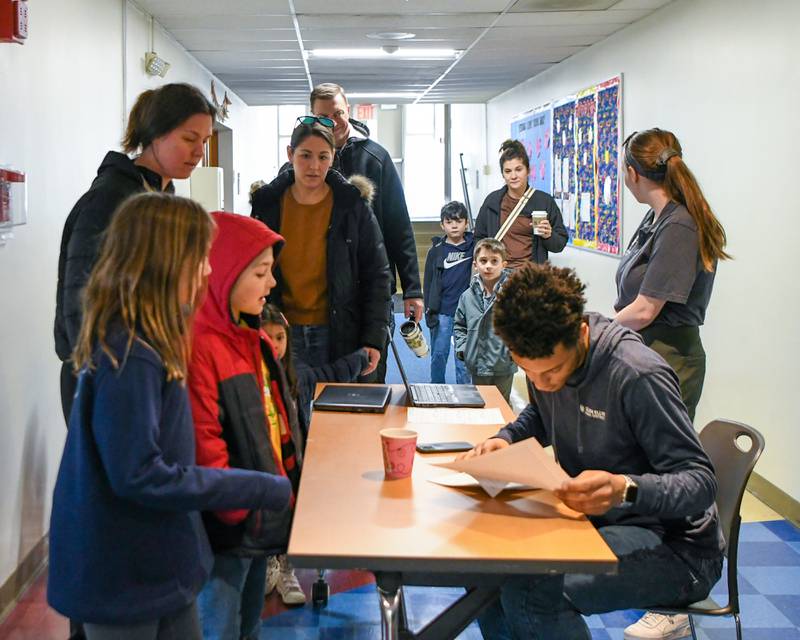 Participants get checked in before the start of the Magic of Gary Kantor magic show held at Main Street Recreation Center in Glen Ellyn on Monday Feb. 19, 2024.