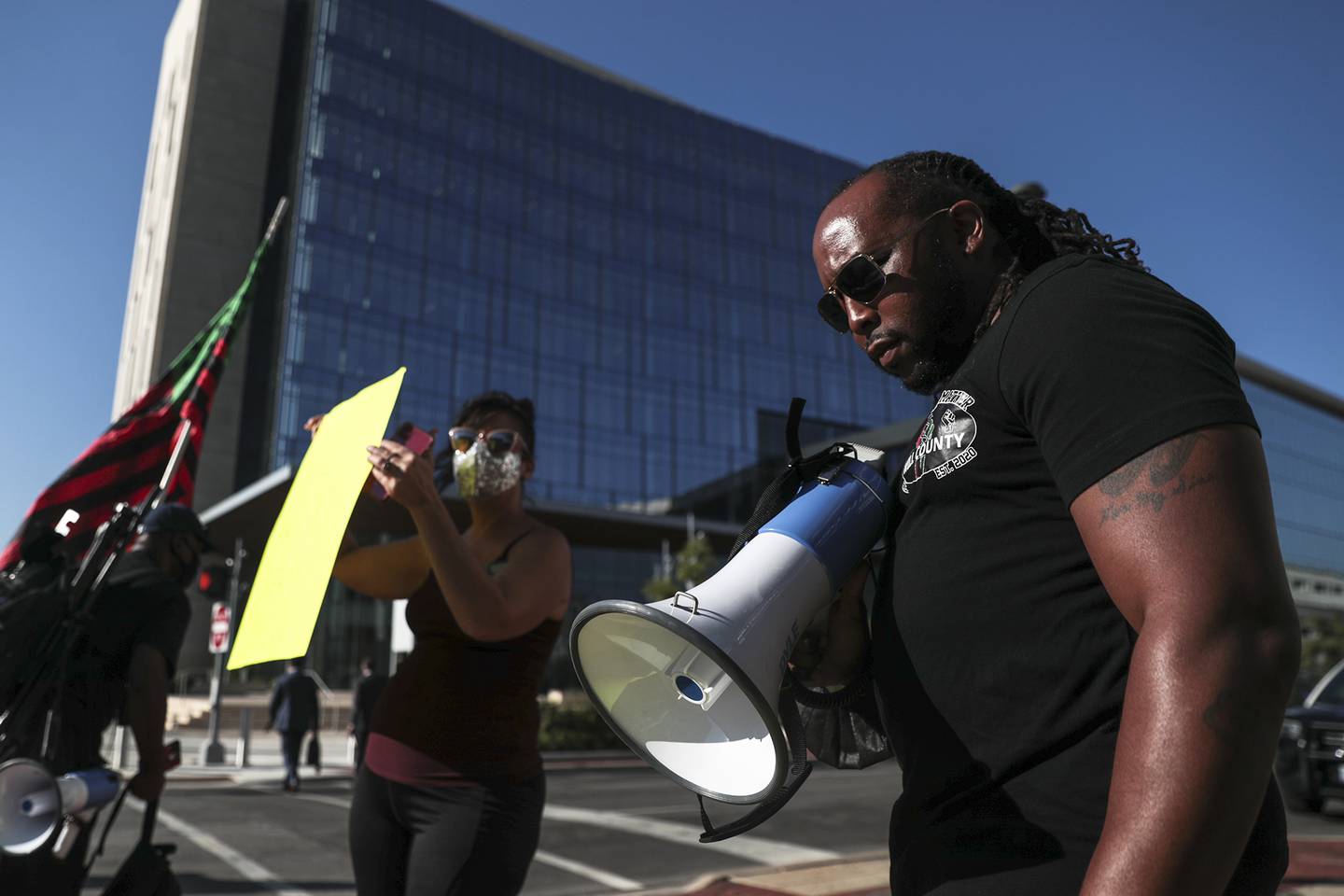 Joliet Black Lives Matter activist Karl Ferrell (right) calls for further investigation into the death of Eric Lurry, a Joliet resident who died while in police custody, on Friday, Sept. 17, 2021, outside of the District Attorney's Office in Joliet, Ill.