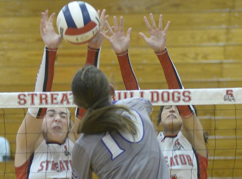 Streator’s Sophia Snow and Sonia Proksa block a spike from Wilmington’s Rachel Smith in the 1st set Thursday at Streator.