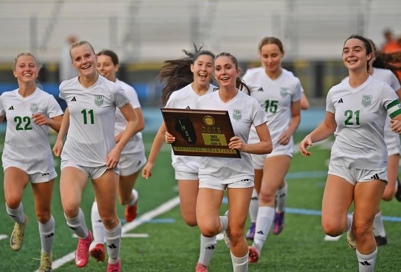 Carrying the Sectional championship plaque is York’s Maggie Quinn, who scored the only goal of the game against Hinsdale Central the Class 3A Downers Grove South Sectional final game on May 30, 2025 at Downers Grove South High School in Downers Grove .