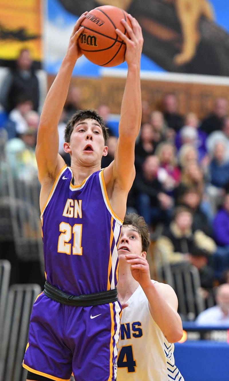 Downers Grove North's Jack Stanton (21) grabs a rebound in front of Lyons Township's Connor Carroll during a game on Jan. 6, 2023 at Lyons Township High School in LaGrange.