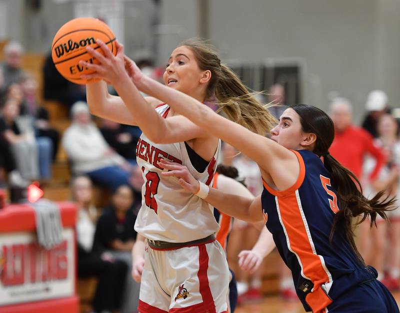 Benet’s Lindsay Harzich grabs a rebound in front of Naperville North’s Ava Podkasik (5) during the Class 4A Benet Regional championship game on February 20, 2025 at Benet Academy in Lisle.
