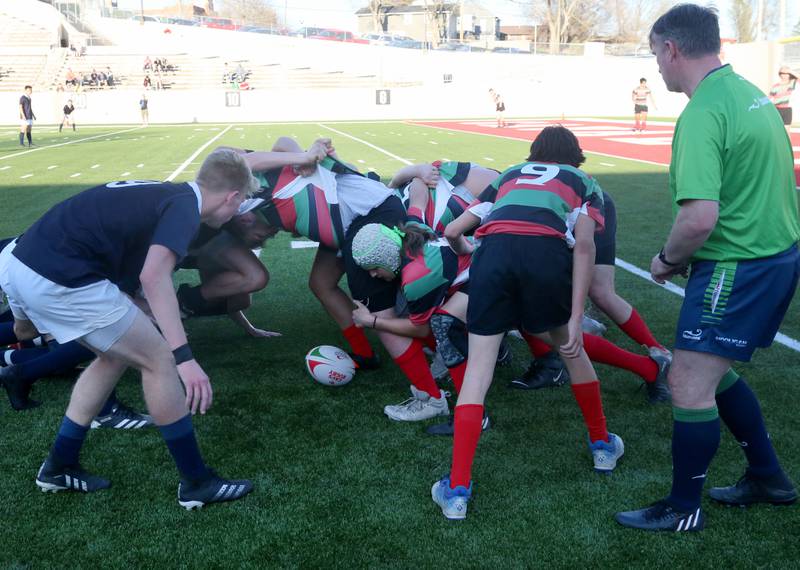 La Salle-Peru and La Salette Academy rugby teams battle during a scrum during a rugby game on Wednesday, April 12, 2023 at Howard Fellows Stadium at L-P High School. A Scrum or scrummage, is a method of restarting play in rugby football that involves players packing closely together to gain possession of the ball.