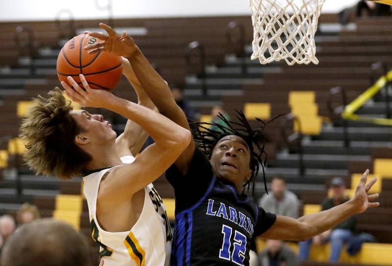 Crystal Lake South's James Carlson drives to the basket against Larkin’s Andre Jones during a Hinkle Holiday Classic basketball game Wednesday, Dec. 28, 2022, at Jacobs High School in Algonquin.