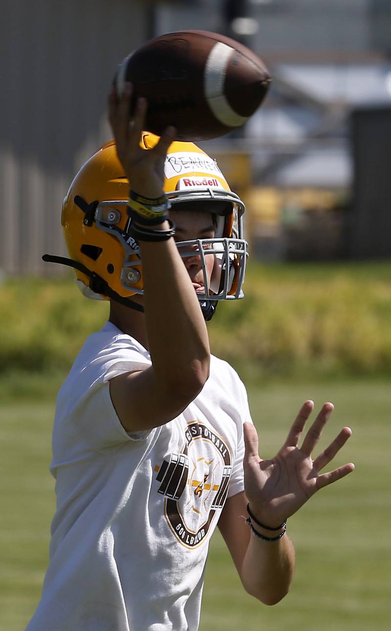 Quarterback Max Benner throws the ball during football practice Monday, June 20, 2022, at Jacobs High School in Algonquin.