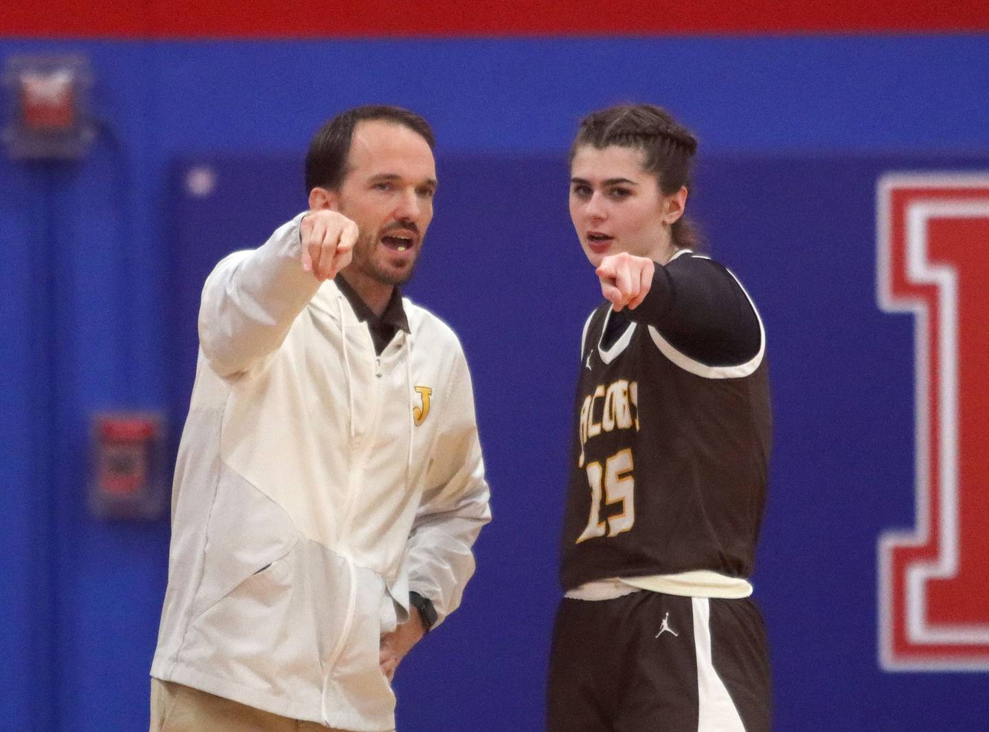 Jacobs’ Head Coach Jonathon Reibel works with Olivia Schuster as the Golden Eagles face Dundee-Crown in varsity girls basketball on Friday, Dec. 12, 2025, at Dundee-Crown High School in Carpentersville.