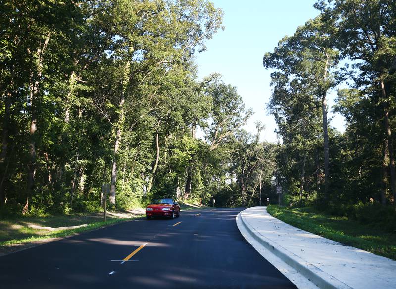 A vehicle drives on the new entrance road to Matthiessen State Park on Tuesday, Aug. 16, 2022 in Oglesby. Crews paved the parking lot and entrance road to Illinois Route 178. A sidewalk was also added along the entrance road.