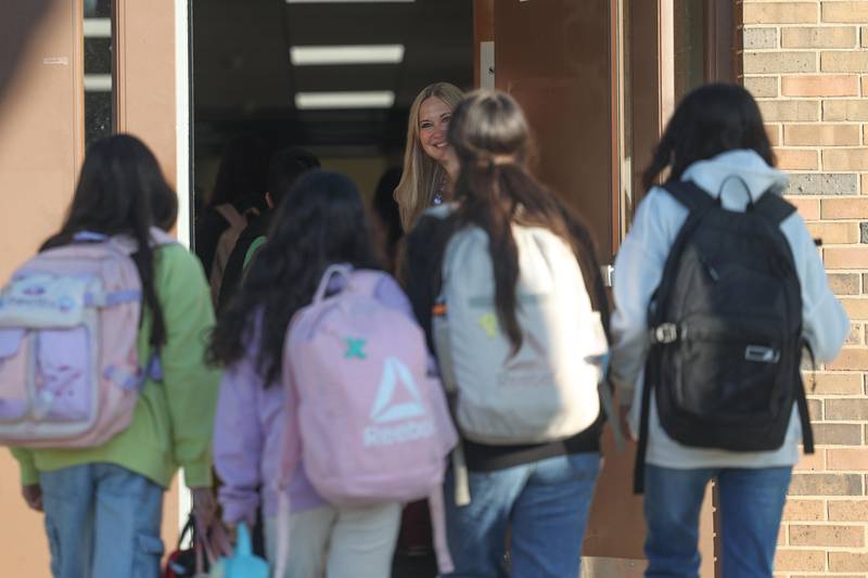 Julianne VanBeveren greets students as they arrive for the first day of school at Dirksen Junior High School on Wednesday, August 21, 2024 in Joliet.