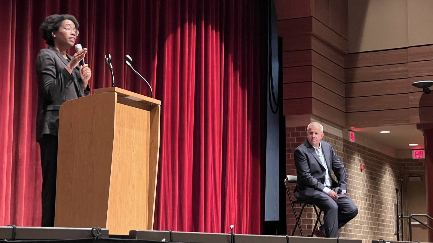 Congresswoman Lauren Underwood, D-Sandwich, speaks during an Aug. 3, 2023 town hall meeting held in DeKalb High School. DeKalb Mayor Cohen Barnes, right, moderated the event.