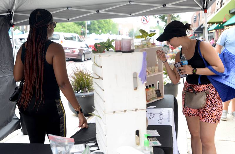 Anastasia Simeakis of LaGrange smells the fragrances of Olive Bath & Body sold by Constance Catlett during the annual LaGrange Craft Fair Saturday July 15, 2023.