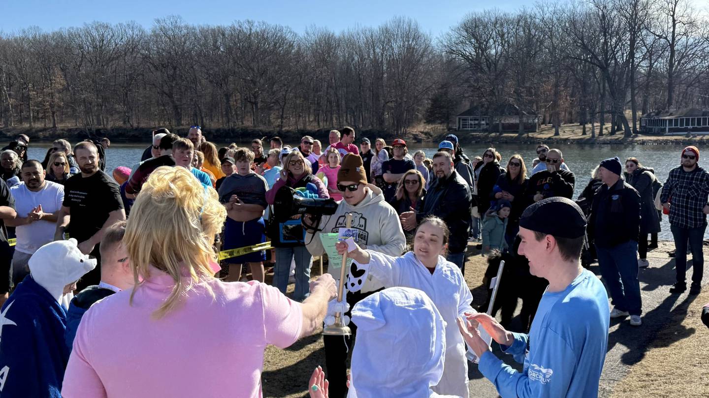 Polar Plunge organizer and St. Charles police officer Jennifer Larsen awards the Silver and Golden Plunger award to the special olympian and community members who raised the most money before taking the plunge in Ferson Creek Park on March 9, 2025.