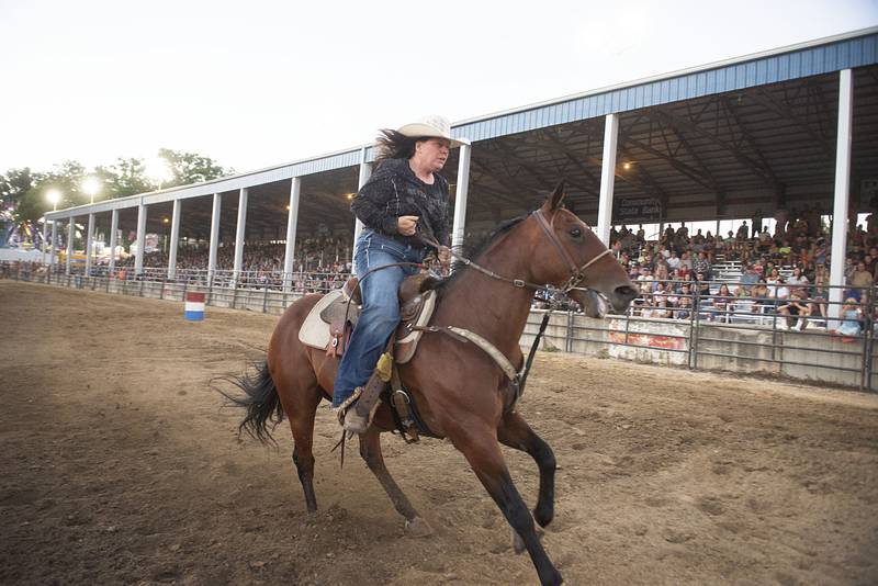 Jill Tretsven heads for the finish in the barrel racing event Tuesday, August 16, 2022 during the Next Level Bull Riding tour at the Whiteside County fair.