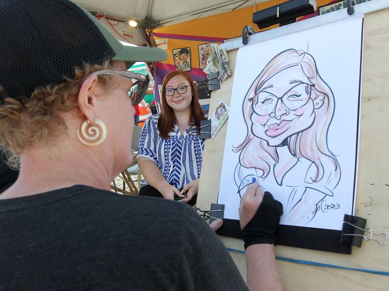 Sarah Jackson, 25, of Wauconda gets her caricature done by Heather Joy, with Otherworld Caricatures, during the Lake County Fair at the Lake County Fairgrounds on Sunday, July 30th in Grayslake.  
Photo by Candace H. Johnson for Shaw Local News Network