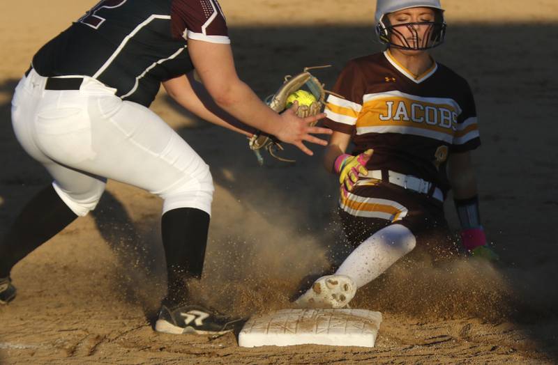 Jacobs' Jianna Tanada slides into third base in front of the brown to Marengo's Mia Miceli during a nonconference softball game on Monday, March 9, 2026, at Marengo High School.