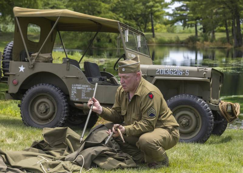 An American reenactor packs up one of the tents that were used to camp in Sunday, July 14, 2024, for the Ottawa Military Show in rural Ottawa.