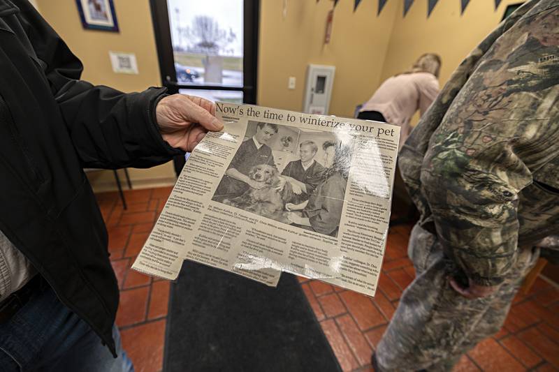 Chapinski shows the clipping he gifted Kuhfus with Thursday, Dec. 28, 2023.