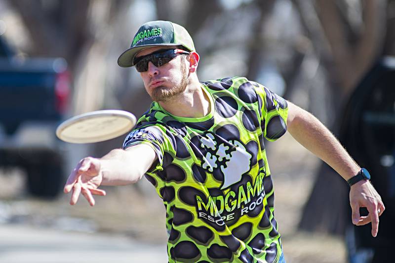 Disc golf player Travis St. Clair of Byron takes a shot towards the basket Sunday, March 13, 2022 at Page Park in Dixon. Rock River Disc Golf sponsored a St. Patrick’s themed tournament in order to raise money for expansion of the course at Page Park and improvements at Sinnissippi Park in Sterling.