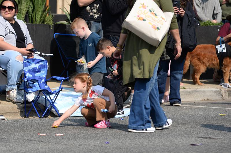 Children including Ana Powers of Clarendon Hills collect candy during the annual LaGrange Pet Parade Saturday May 31, 2025.