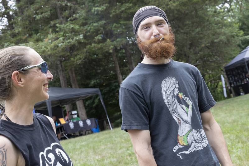 Breanna Greenwald and Justin Moyers of La Moille enjoy a smoke Friday, June 27, 2025, during Herbal Root’s CannaFest in Nelson. The third annual event moved to Who Else Land for the 2025 festival.