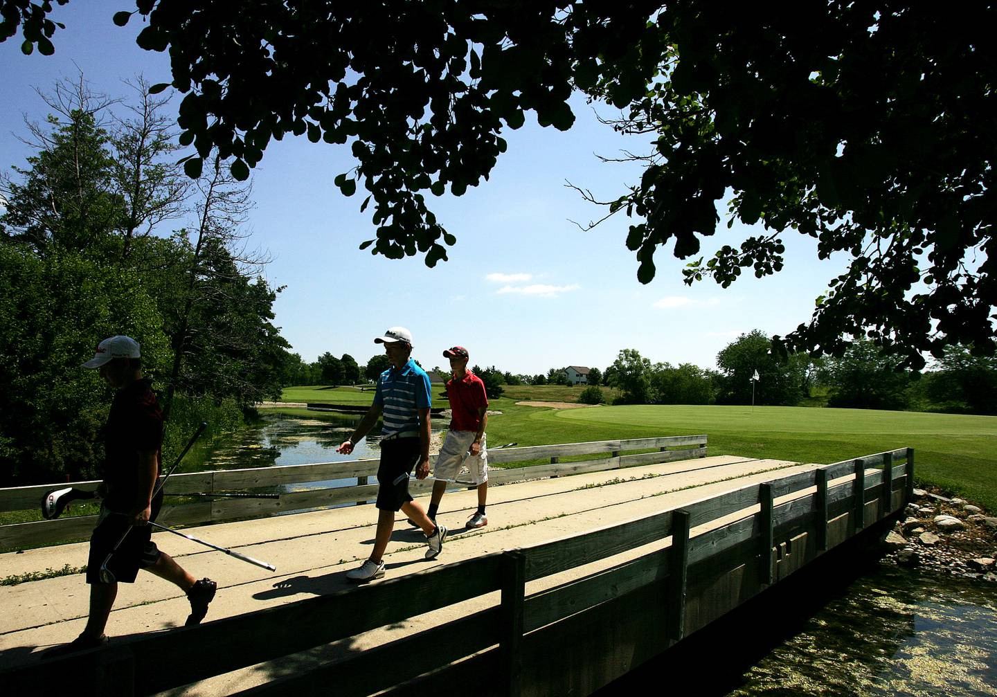 Jake Bowser (left), Connor Sullivan (center) and Brad Spoeth walk to hole 16 during the McHenry County Junior Golf Association's Redtail Open Tournament Wednesday, June 19, 2013 at the Redtail Golf Course in Lakewood.