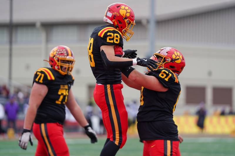 Batavia’s Bradyn Martinson (61) lifts Nathan Whitwell (28) into the air after Whitwell scored a touchdown against Downers Grove North during a class 7A quarterfinal playoff football game at Batavia High School on Saturday, Nov. 16, 2024.