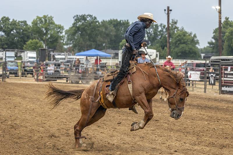 Cowboy Kamis Bullis works to hang onto “Lucky Duck” Wednesday, Aug. 14, 2024, at the Whiteside County Fair in Morrison.