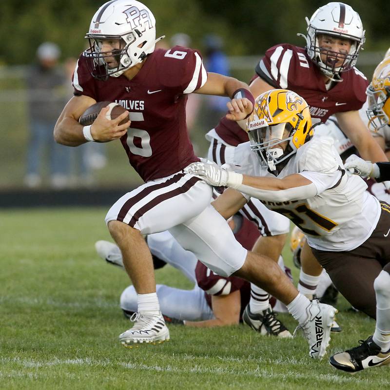 Prairie Ridge's Luke Vanderwiel breaks away from the tackle attempt of Jacobs' Nick Meyer on his way to a touchdown during a Fox Valley Conference football game on Friday, Sept. 5, 2025, at Prairie Ridge High School in Crystal Lake.