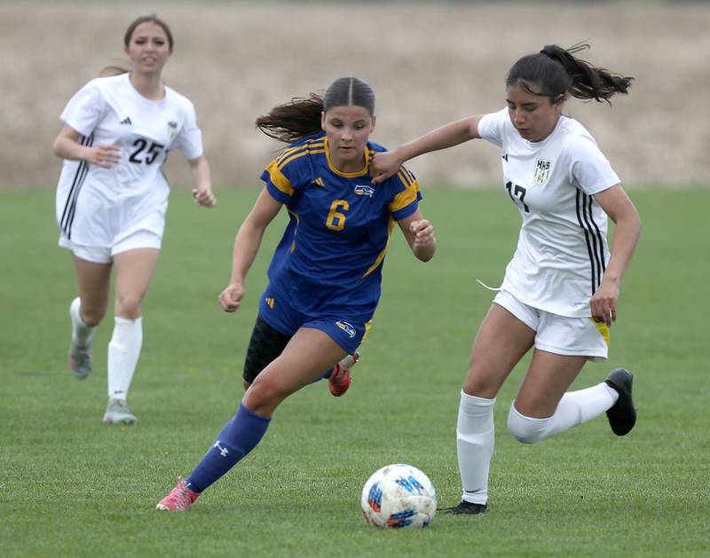 Johnsburg's Liz Smith battles with Harvard's Aimar Citlali Nava during a Kishwaukee River Conference soccer match on Wednesday, April 27, 2026, at Johnsburg High School.