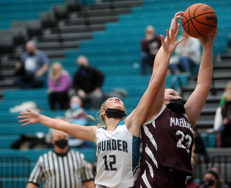 Woodstock North's Addison Rishling battles with Marengo’s Morgan Coffman for a rebound during the second quarter of a Kishwaukee River Conference girls basketball between Marengo and Woodstock North Wednesday evening, Jan. 12, 2022, at Woodstock North High School.