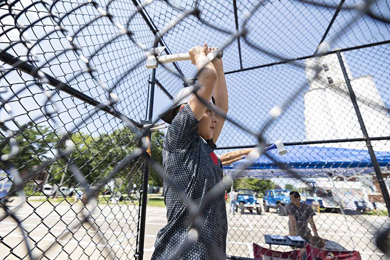 Kyhlor Thomas, 10, of Tampico lines up his shot at the Whoop Your Axe axe throwing booth on display Saturday, July 22, 2023 at Tampico Days.
