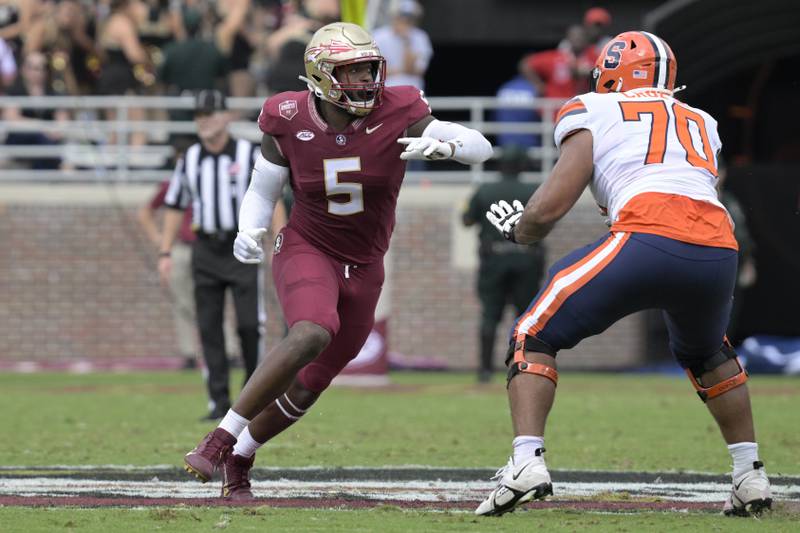 Florida State defensive lineman Jared Verse (5) works against Syracuse offensive lineman Enrique Cruz Jr. (70) during the first half of an NCAA college football game, in Tallahassee, Fla. (AP Photo/Phelan M. Ebenhack)