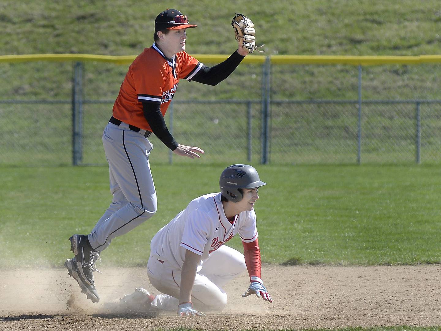 Ottawa’s Payton Knoll  looks for the call after being tagged out by Washington’s Brock Maxwell at 2nd base in the 3rd inning on Saturday, April 8, 2023 at Ottawa High School.