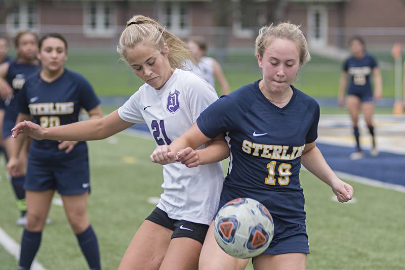 Dixon's Rylee Pfoutz and Sterling's Olivia Niedermann battle for a loose ball Tuesday, May 10, 2022.