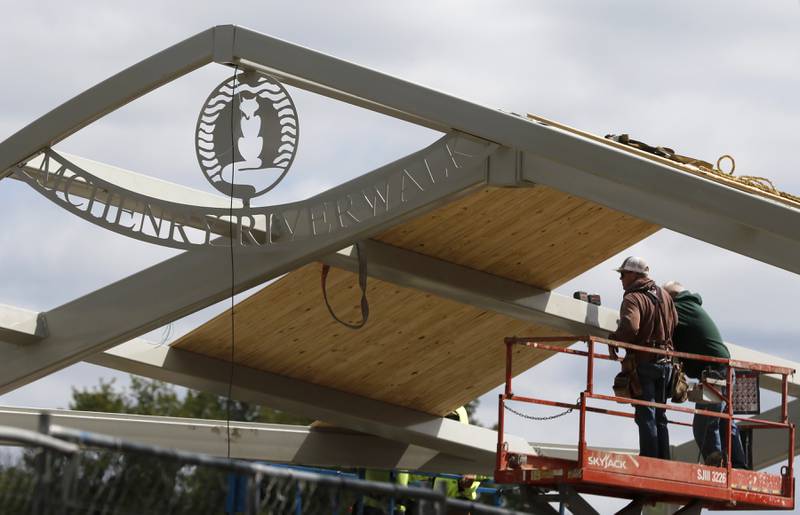 Workers install a roof on the amphitheater at Miller Point Park on Aug. 30, 2023. The city started construction on March 20 to upgrade Miller Point Park, which will be officially unveiled to the public on Saturday at Light the Night. The $2.27 million construction cost includes nearly $600,000 in private donations.