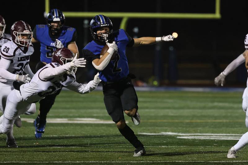 Lincoln-Way East’s James Kwiecinski evades a tackle on a run against Lockport Friday night.